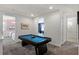 Bright game room featuring a pool table, carpeted floors and multiple entrances to other rooms at 7527 Marker Ave, Kissimmee, FL 34747
