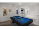 Game room with blue pool table and washer and drier in the background at 7527 Marker Ave, Kissimmee, FL 34747
