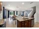 Open-concept kitchen with granite island, dining area, and seamless flow into the living space at 7527 Marker Ave, Kissimmee, FL 34747