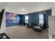Spacious entertainment room with a large screen projector, couch, and natural lighting at 7527 Marker Ave, Kissimmee, FL 34747