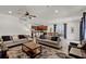 Open concept living room with couches, rug, curtains, and views of kitchen and dining areas at 7527 Marker Ave, Kissimmee, FL 34747