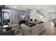 Comfortable living room with gray couches, neutral walls, a ceiling fan, and a television with a view of the neighborhood at 7527 Marker Ave, Kissimmee, FL 34747