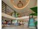Expansive lobby with high ceilings, a reception area, colorful stairs, and modern design elements at 7527 Marker Ave, Kissimmee, FL 34747