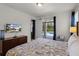 Spacious primary bedroom suite features a walkout to the pool and an exterior view on the television at 7527 Marker Ave, Kissimmee, FL 34747