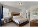 Comfortable primary bedroom suite with a large bed, carpeted floors, and an attached bathroom at 7527 Marker Ave, Kissimmee, FL 34747
