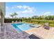 Beautiful backyard pool and spa surrounded by lush landscaping and privacy hedges at 7527 Marker Ave, Kissimmee, FL 34747