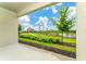 A serene back patio view of the neighborhood park and lush greenery at 8967 Chipping Square Ln, Davenport, FL 33896