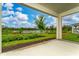 A serene back patio view of the neighborhood pond and lush greenery at 8967 Chipping Square Ln, Davenport, FL 33896