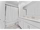 Bathroom featuring double vanity, framed mirror, tiled floors, and shower with white curtain at 8967 Chipping Square Ln, Davenport, FL 33896