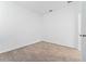 Bright bedroom with carpeted floors, neutral walls, and a doorway leading to the rest of the home at 8967 Chipping Square Ln, Davenport, FL 33896
