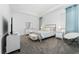 A stylish bedroom featuring neutral tones, modern furniture, and soft, natural light at 8967 Chipping Square Ln, Davenport, FL 33896