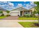 Charming single-Gathering home with a brick driveway and well-maintained landscaping at 8967 Chipping Square Ln, Davenport, FL 33896