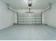 A spacious two car garage with plenty of room for parking and storage at 8967 Chipping Square Ln, Davenport, FL 33896