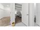 Hallway showing a bedroom and a walk-in closet with metal racks and a toilet at 8967 Chipping Square Ln, Davenport, FL 33896