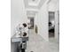 Bright hallway featuring modern tile flooring and stylish decor leading to bedroom at 8967 Chipping Square Ln, Davenport, FL 33896