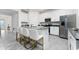 Modern kitchen featuring white cabinetry, stainless steel appliances, and a center island at 8967 Chipping Square Ln, Davenport, FL 33896