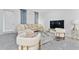 Cozy living room features a comfortable sectional and stylish decor at 8967 Chipping Square Ln, Davenport, FL 33896