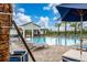 Beautiful community pool area with comfortable lounge chairs, palm trees, and a covered pavilion, perfect for relaxing at 8967 Chipping Square Ln, Davenport, FL 33896