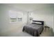 Simple bedroom featuring two windows, neutral carpet, and a minimalist aesthetic at 9004 Santorini Dr, Orlando, FL 32827