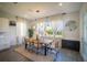 Bright dining room with a modern chandelier, large windows, and stylish decor accents at 9004 Santorini Dr, Orlando, FL 32827