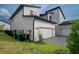 Two-story home with a two car garage and landscaped yard, view from side at 9004 Santorini Dr, Orlando, FL 32827