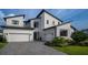 Charming two-story home with modern architectural details, a well maintained yard, and spacious garage at 9004 Santorini Dr, Orlando, FL 32827