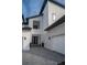Striking modern home featuring a stone facade, black-framed windows, and a gray brick driveway at 9004 Santorini Dr, Orlando, FL 32827