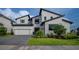 Stunning two-story home with modern architecture, manicured lawn, and a spacious two car garage at 9004 Santorini Dr, Orlando, FL 32827