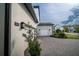Side view of home showing garage, paved driveway, and nicely landscaped yard at 9004 Santorini Dr, Orlando, FL 32827