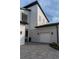 Home's front entrance features stone accents, a paved driveway and a two car garage at 9004 Santorini Dr, Orlando, FL 32827