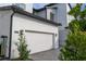 Two car garage with stone accents and sleek exterior lighting at 9004 Santorini Dr, Orlando, FL 32827