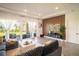 Contemporary living room with a textured accent wall and sliding glass doors leading to the patio at 9004 Santorini Dr, Orlando, FL 32827