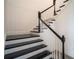 Modern staircase with black treads and white risers, showcasing a clean and stylish design at 9004 Santorini Dr, Orlando, FL 32827