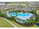 Aerial view of community pool, clubhouse, and lush landscaping at 9318 Mclaren Aly, Winter Garden, FL 34787