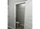 A half bathroom with tile flooring and a toilet at 9318 Mclaren Aly, Winter Garden, FL 34787