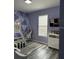 Bright bedroom showcasing a hanging chair, geometric wall art, and a window at 9318 Mclaren Aly, Winter Garden, FL 34787
