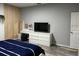 Bright bedroom with a vanity, a television, and wood accent wall at 9318 Mclaren Aly, Winter Garden, FL 34787