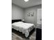 Bedroom featuring grey walls, wood floors and a comfortable bed at 9318 Mclaren Aly, Winter Garden, FL 34787