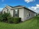 Exterior of a single-story home featuring a lush green lawn and well-maintained landscaping at 9318 Mclaren Aly, Winter Garden, FL 34787