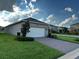 Exterior view of a home with a spacious driveway leading to a convenient two-car garage at 9318 Mclaren Aly, Winter Garden, FL 34787