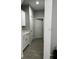 Hallway with white cabinets, countertops, and modern flooring at 9318 Mclaren Aly, Winter Garden, FL 34787