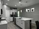 Spacious kitchen featuring a large center island with quartz countertops and stainless steel appliances at 9318 Mclaren Aly, Winter Garden, FL 34787