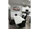 Open concept dining area that connects to the kitchen with modern table and chairs at 9318 Mclaren Aly, Winter Garden, FL 34787