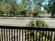 A cozy balcony with a scenic view of swaying trees and lush landscaping at 940 Fenton Ln # 8, Lakeland, FL 33809