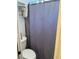 Cozy bathroom with a toilet and a shower with a gray shower curtain at 940 Fenton Ln # 8, Lakeland, FL 33809