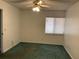 This bedroom features a ceiling fan, window with blinds, and green carpet at 940 Fenton Ln # 8, Lakeland, FL 33809