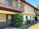 Exterior view of the building with beige siding and a small balcony on the second floor at 940 Fenton Ln # 8, Lakeland, FL 33809