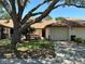 Charming one-story home with a large shade tree and attached one-car garage at 940 Fenton Ln # 8, Lakeland, FL 33809
