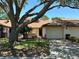 Charming one-story home with a large shade tree and attached one-car garage at 940 Fenton Ln # 8, Lakeland, FL 33809