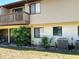 Exterior view of the building with beige siding and a small balcony on the second floor at 940 Fenton Ln # 8, Lakeland, FL 33809